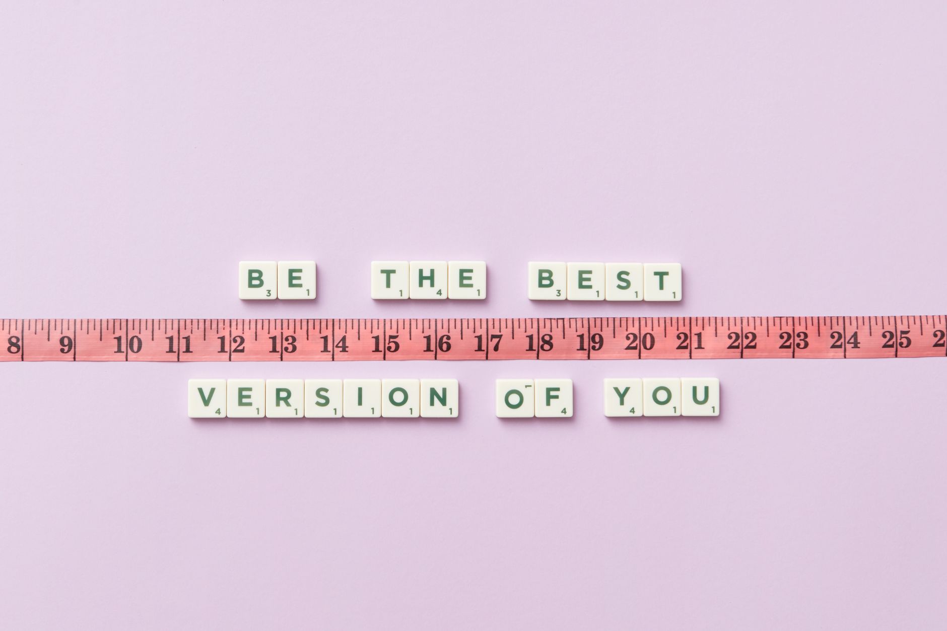 Motivational phrase 'Be the Best Version of You' with a measuring tape on purple background.