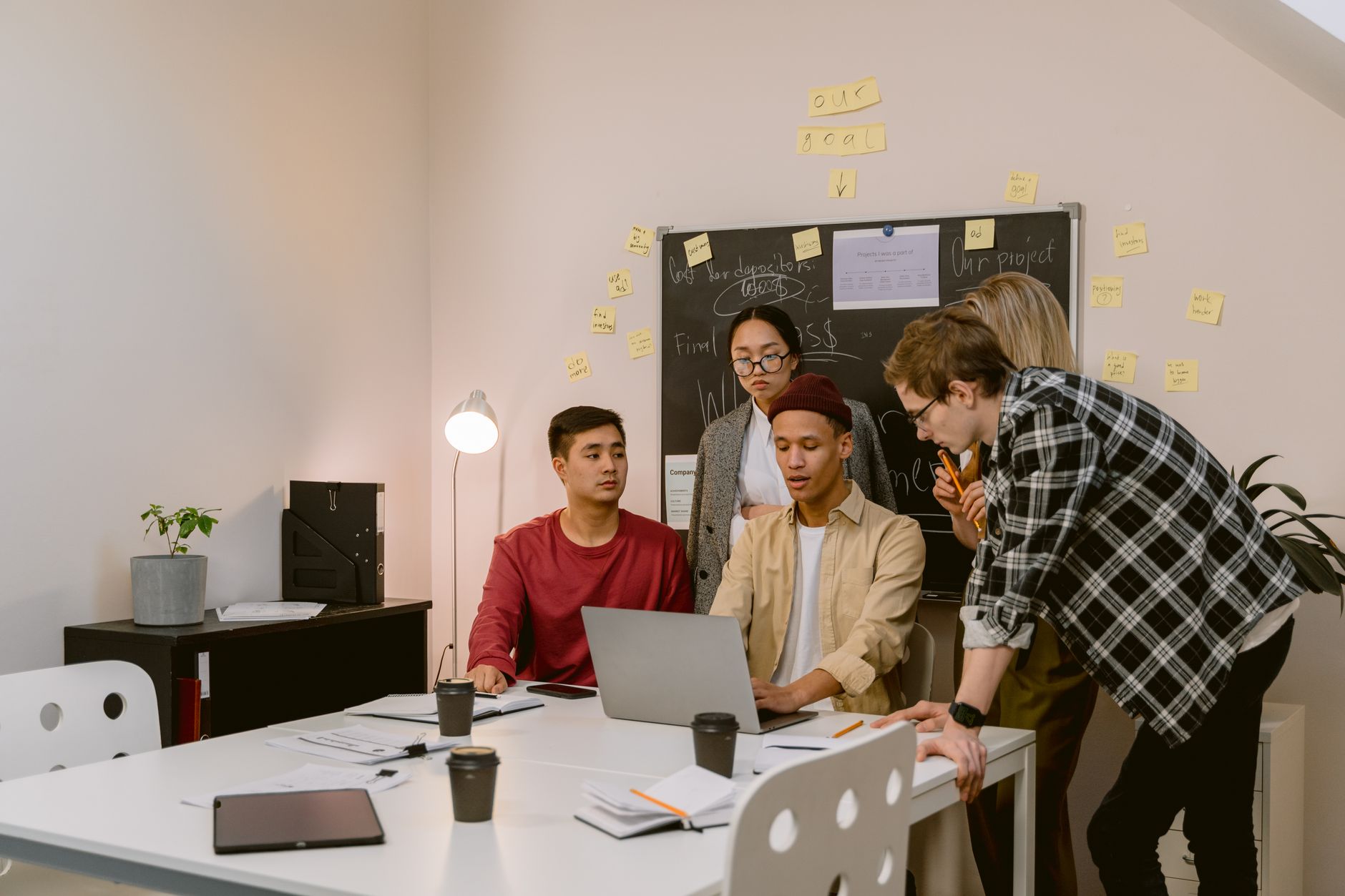 Group of young professionals brainstorming ideas in a collaborative office environment.