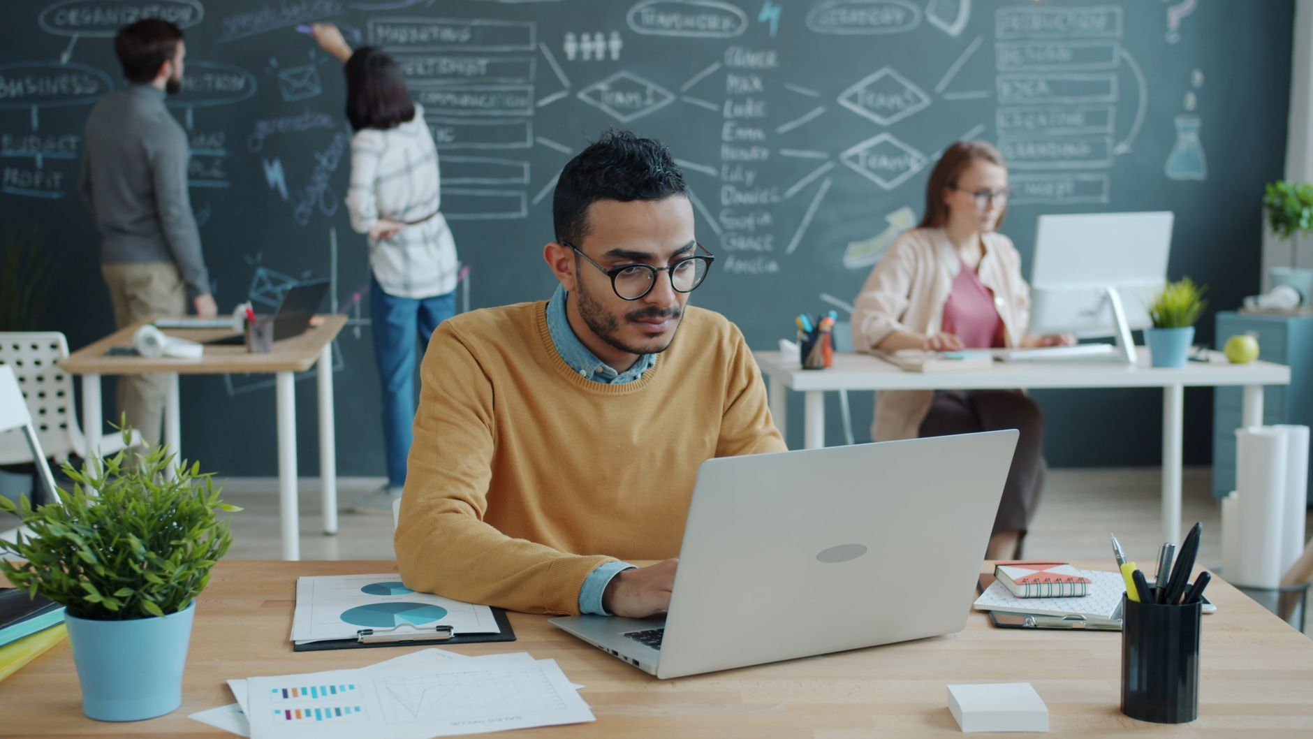 Young professionals collaborating in a modern, creative workplace.