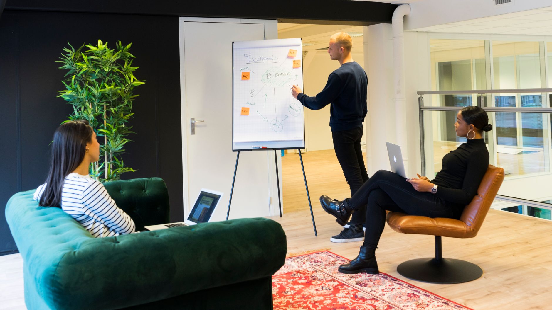 A group of professionals engaged in a collaborative meeting in a bright, modern office environment.
