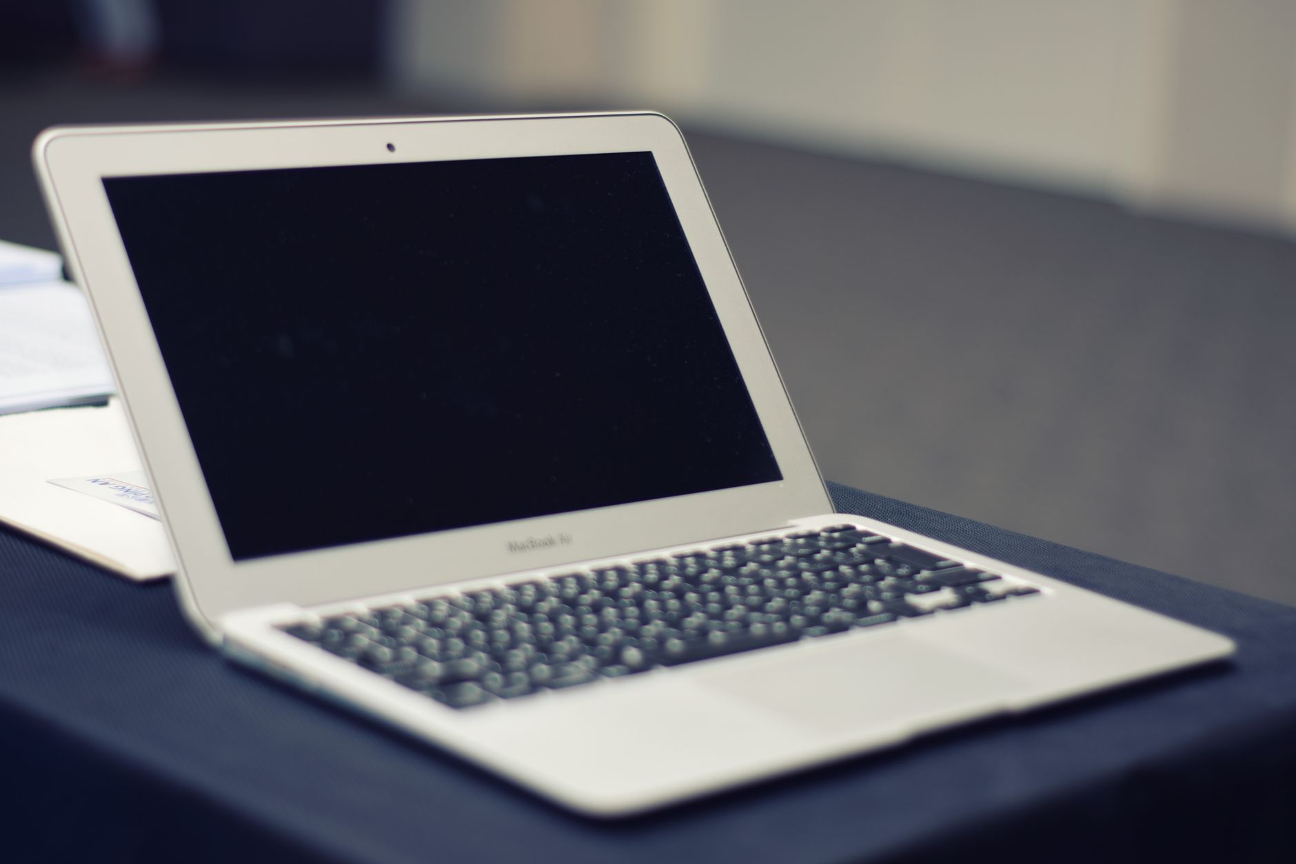 Elegant MacBook Air laptop with blank screen on a desk, showcasing modern technology.