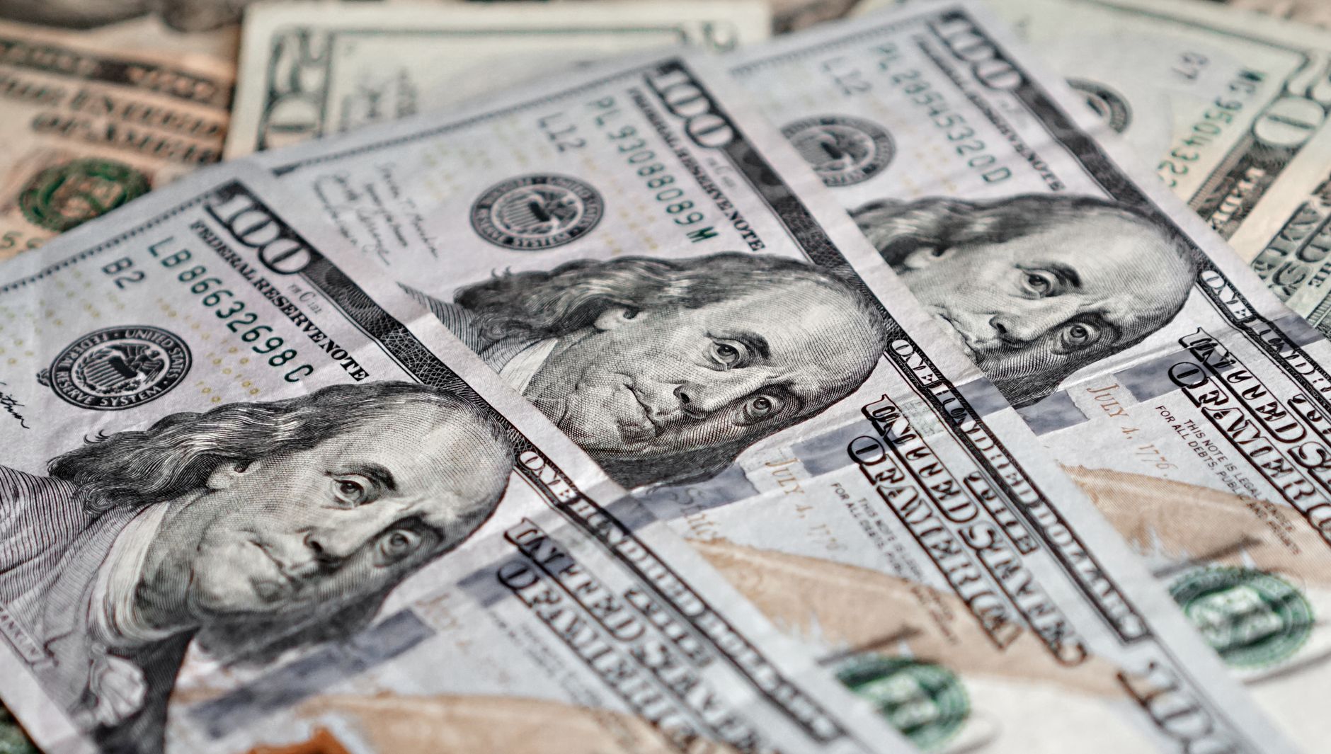 Detailed image of hundred dollar bills, showcasing US currency and finance concept.