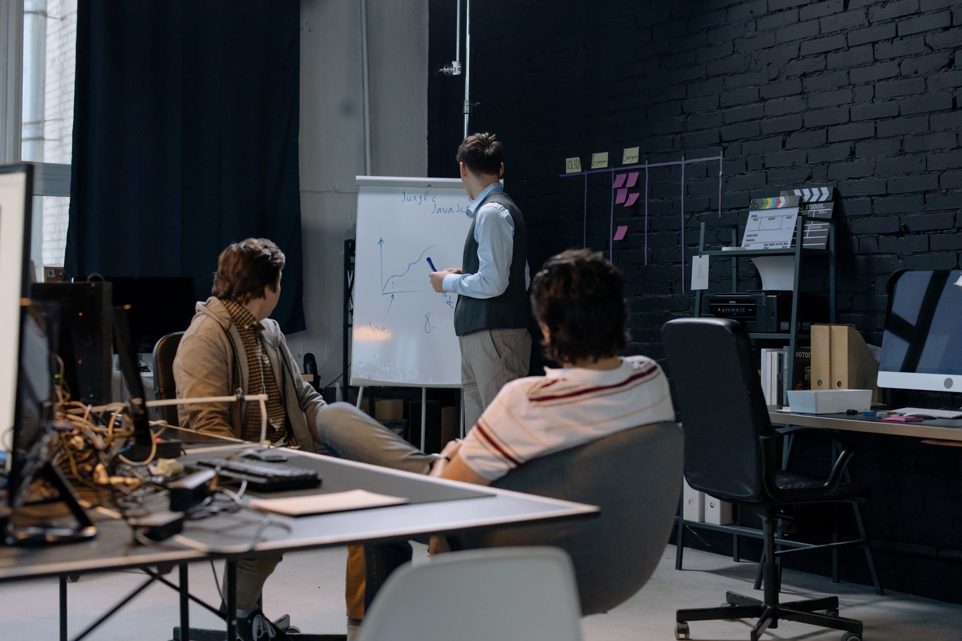 Business meeting with a presentation on growth charts in a contemporary office setting.
