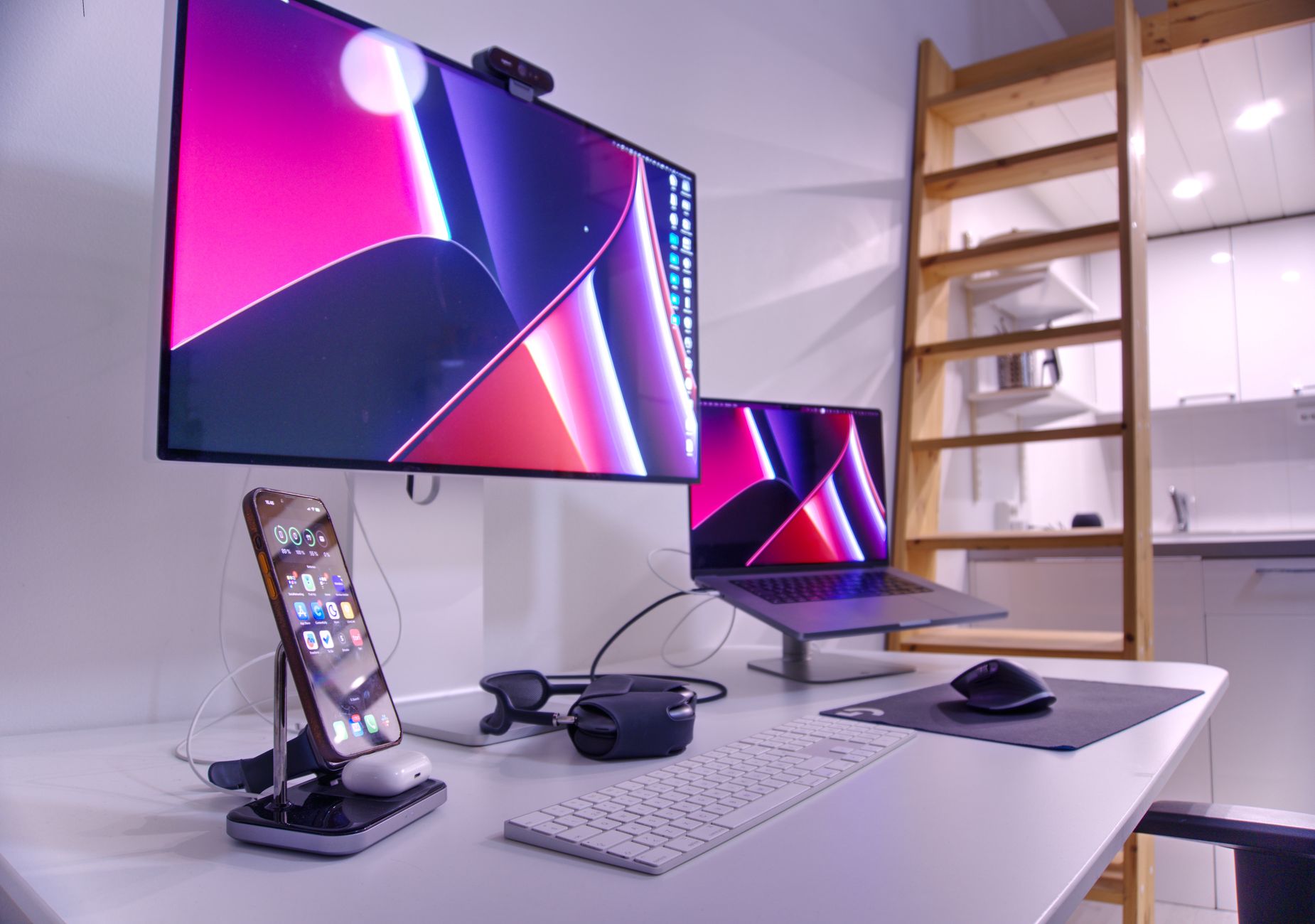 Stylish home office desk with dual screens, smartphone, and tech accessories in Helsinki, Finland