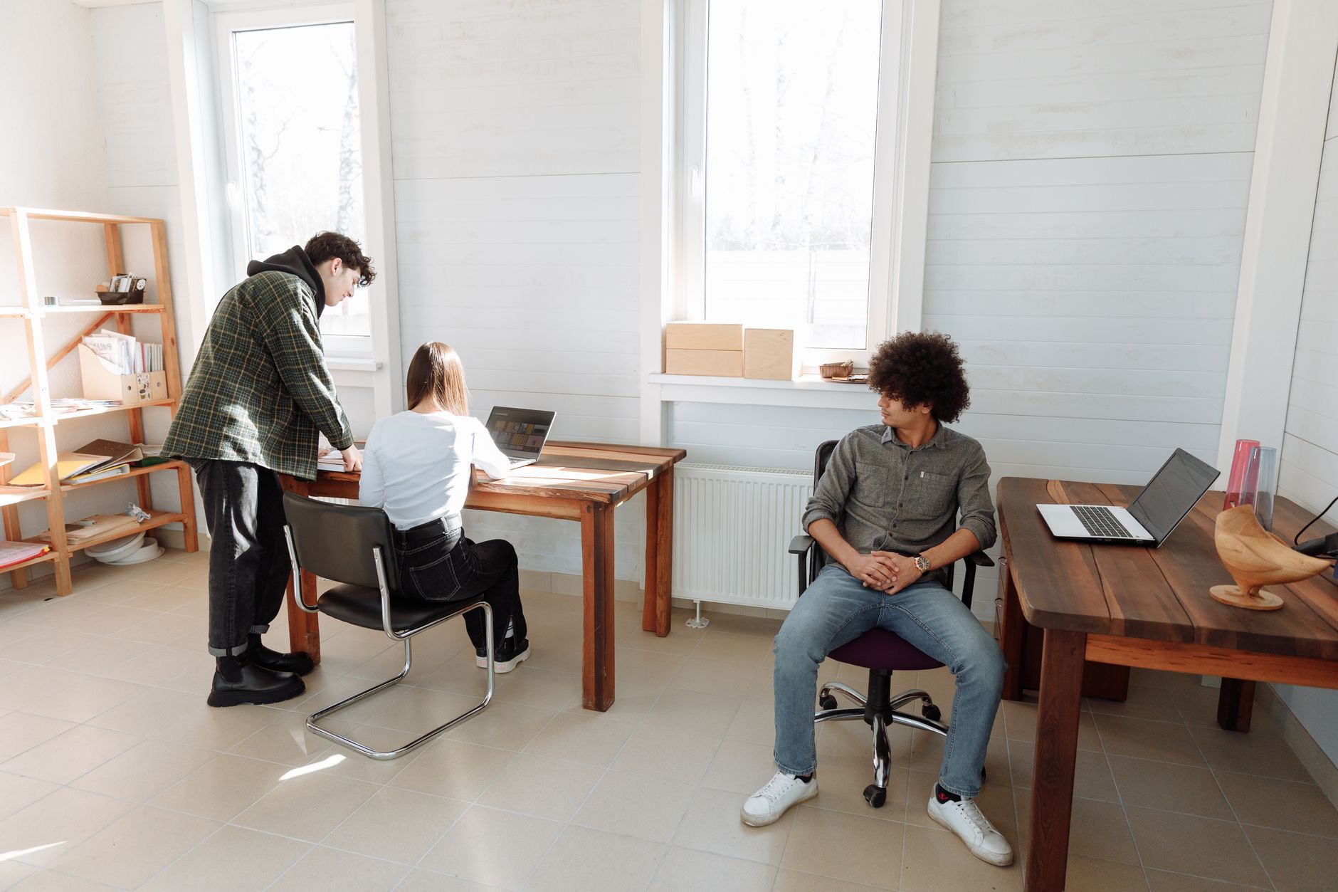 Young professionals collaborating in a modern office space, illustrating teamwork and creativity.