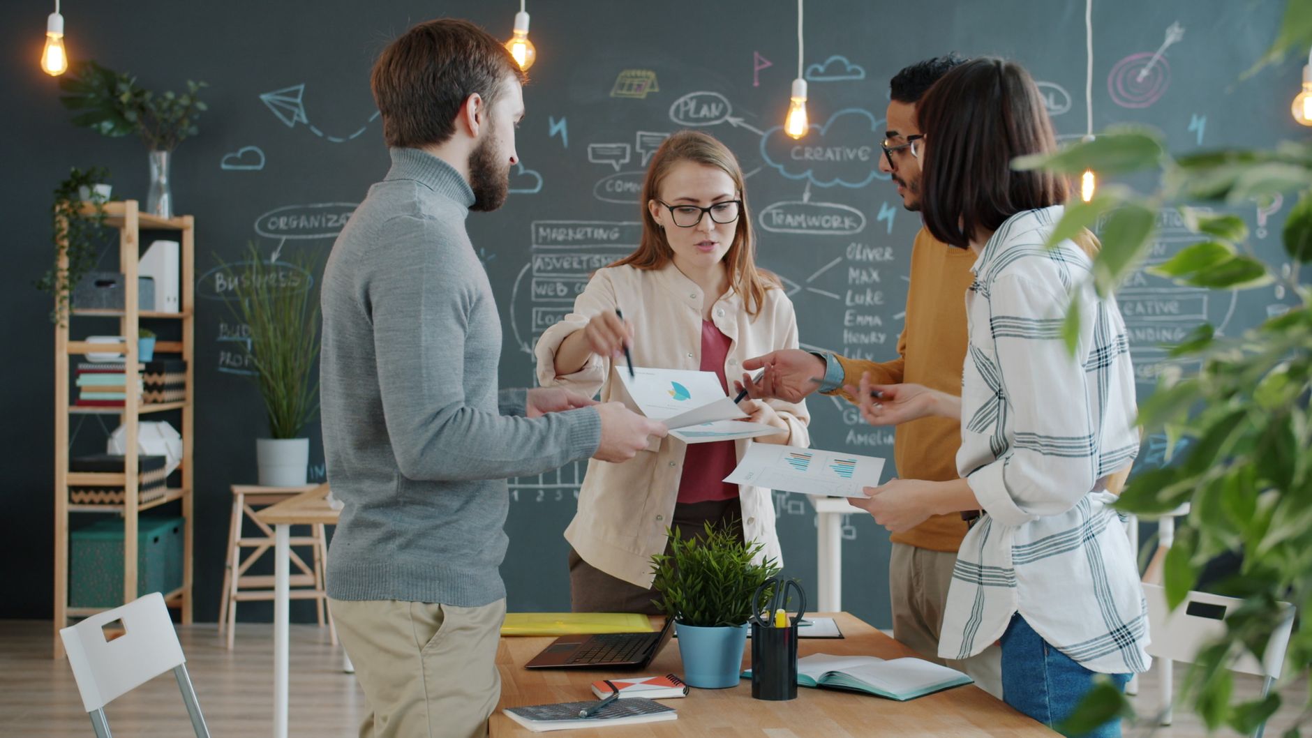 Dynamic group of young professionals collaborating in a modern office setting.