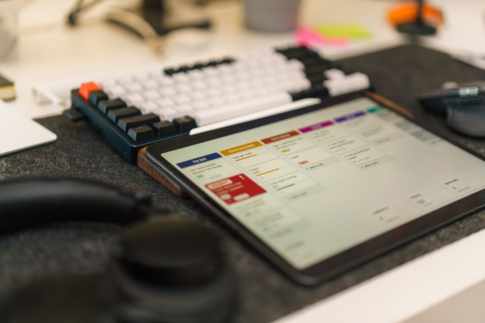 Tech-focused workspace featuring a tablet, mechanical keyboard, and productivity app for efficient task management.