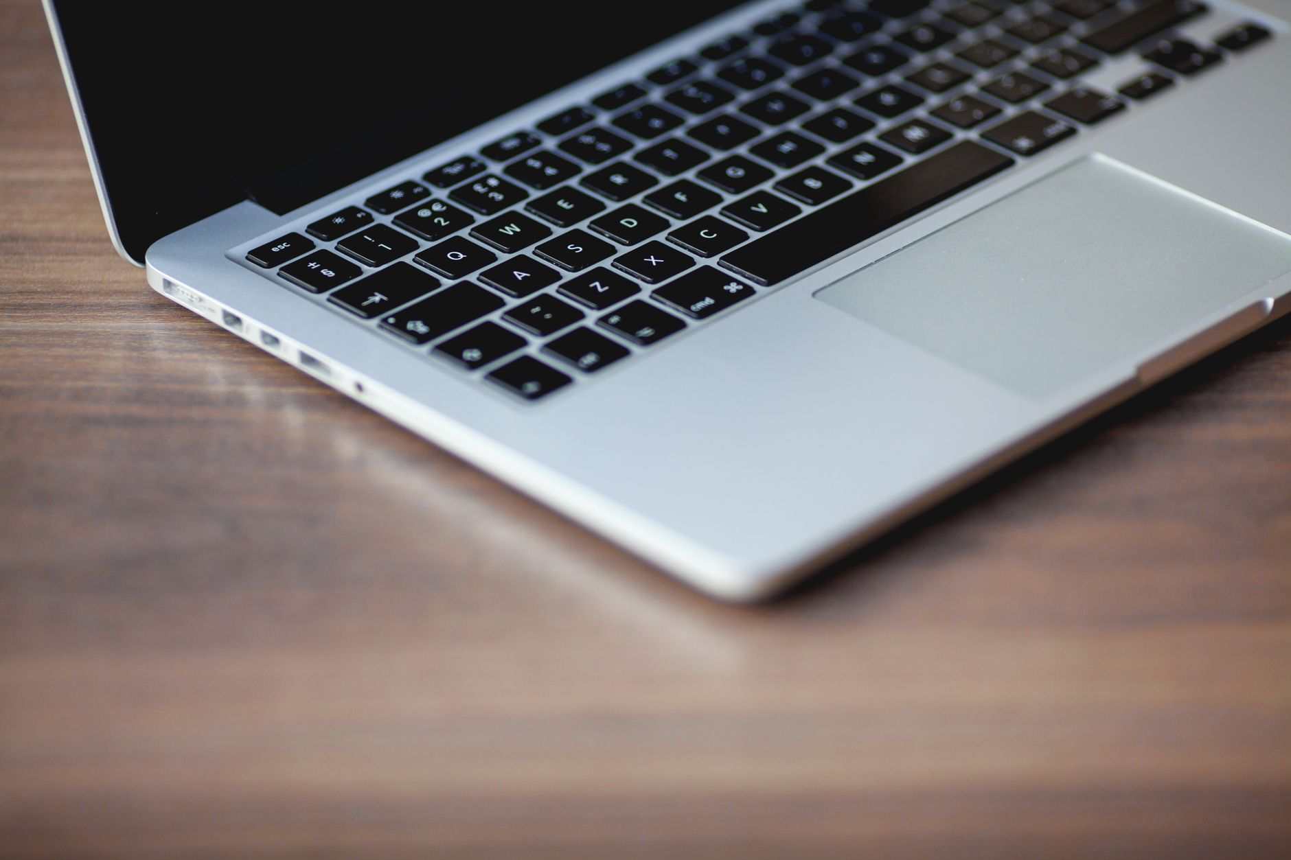 A sleek laptop on a wooden surface, showcasing elegant design and technology.
