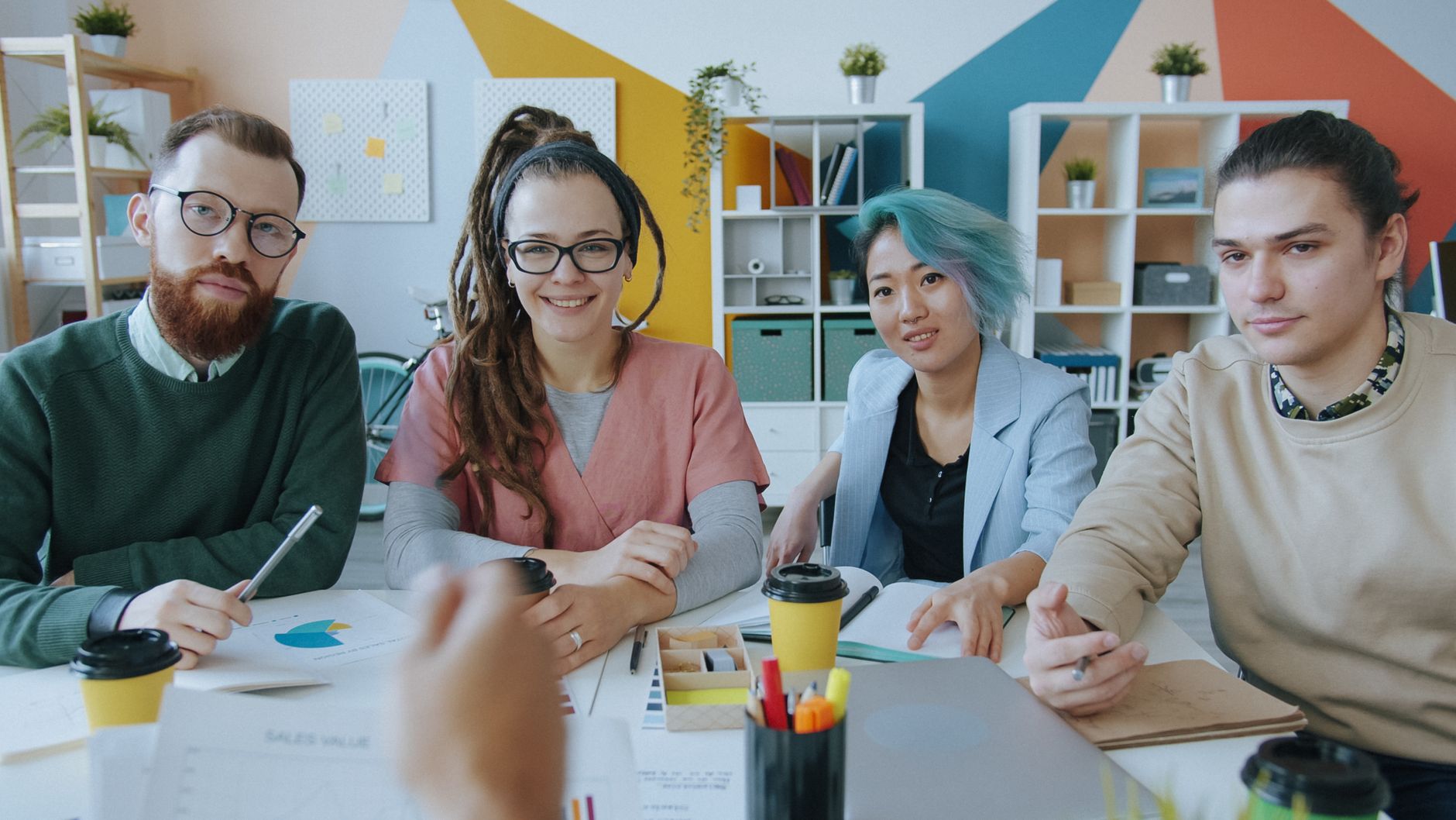 A diverse group of professionals collaborating in a modern office setting, showcasing teamwork.