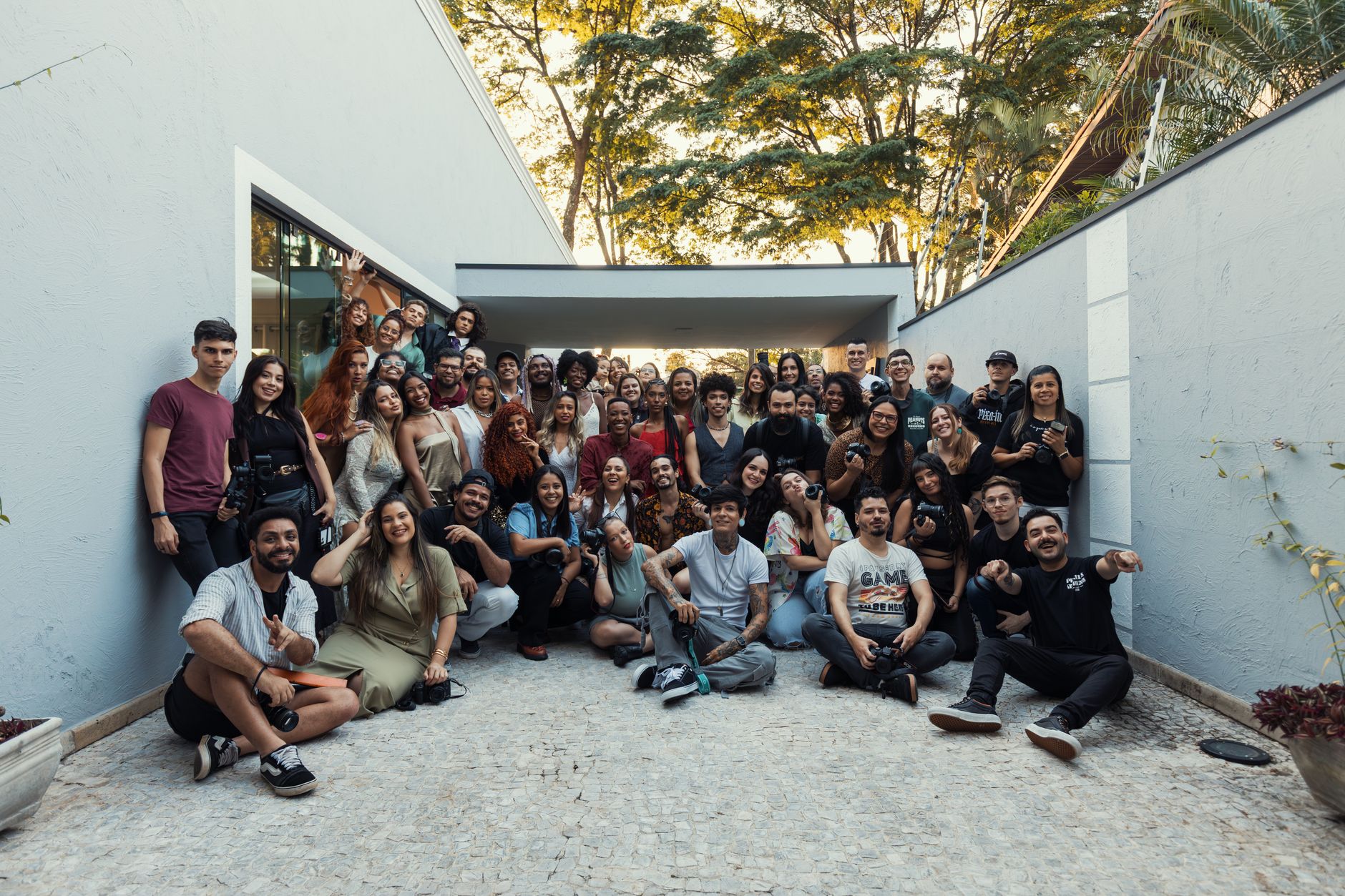 A diverse crowd of adults gathered outdoors, showcasing teamwork and camaraderie in a casual environment.