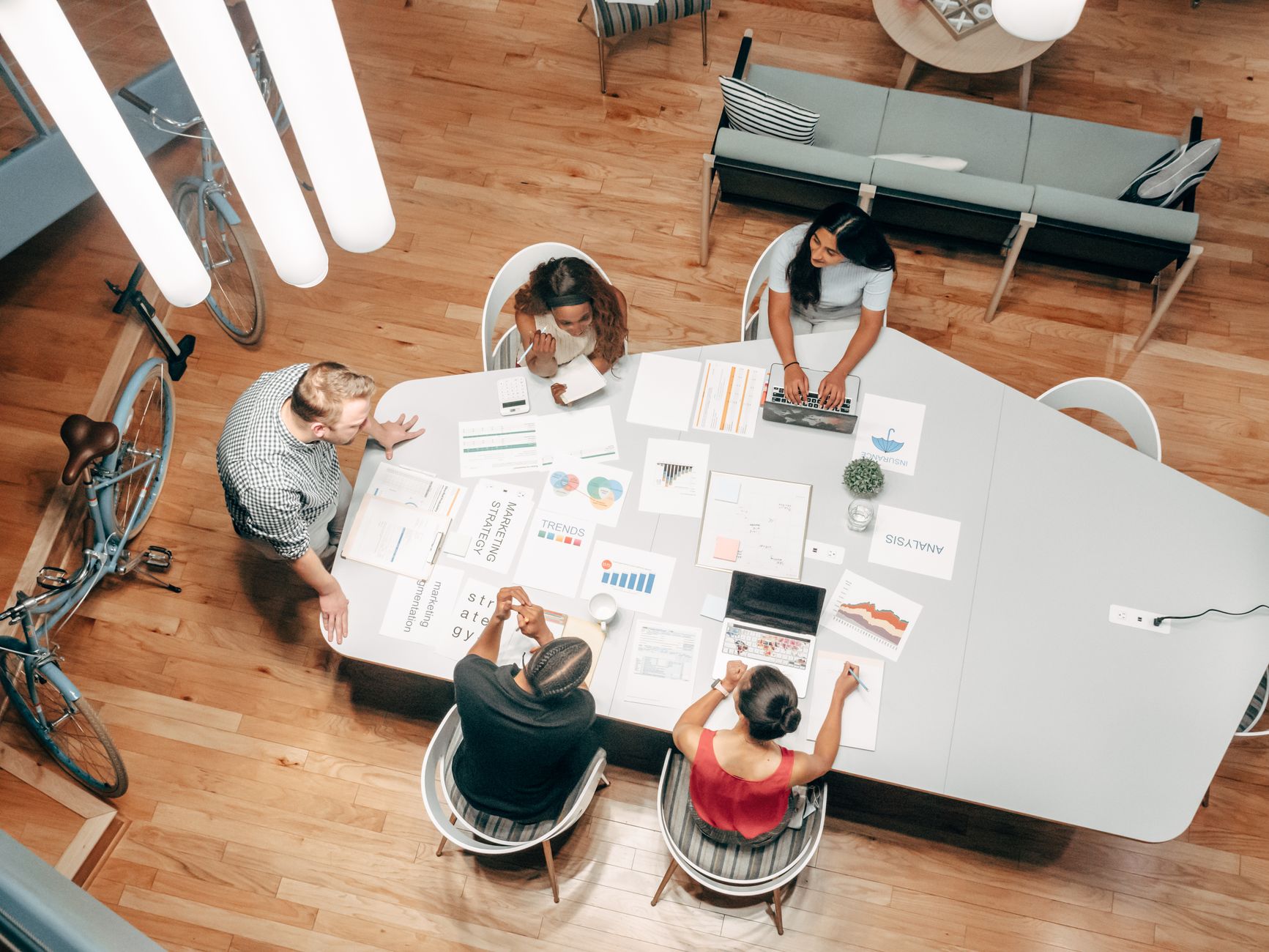 Top view of diverse colleagues having a discussion at a modern office table.
